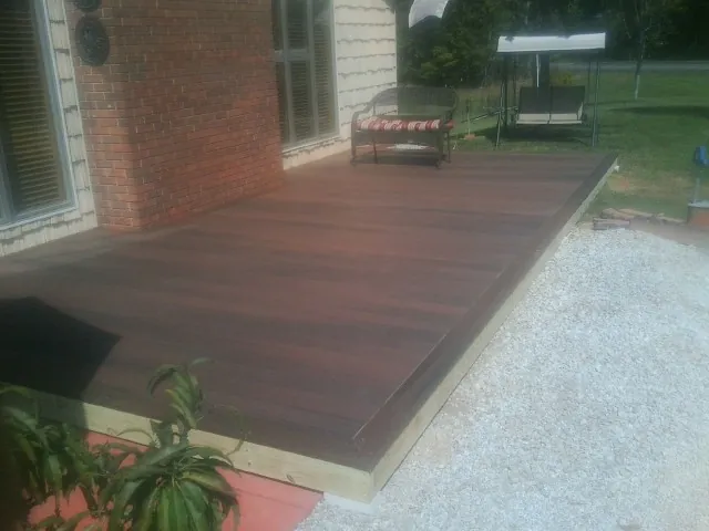 Freshly stained wood deck built against a brick home in Eldorado